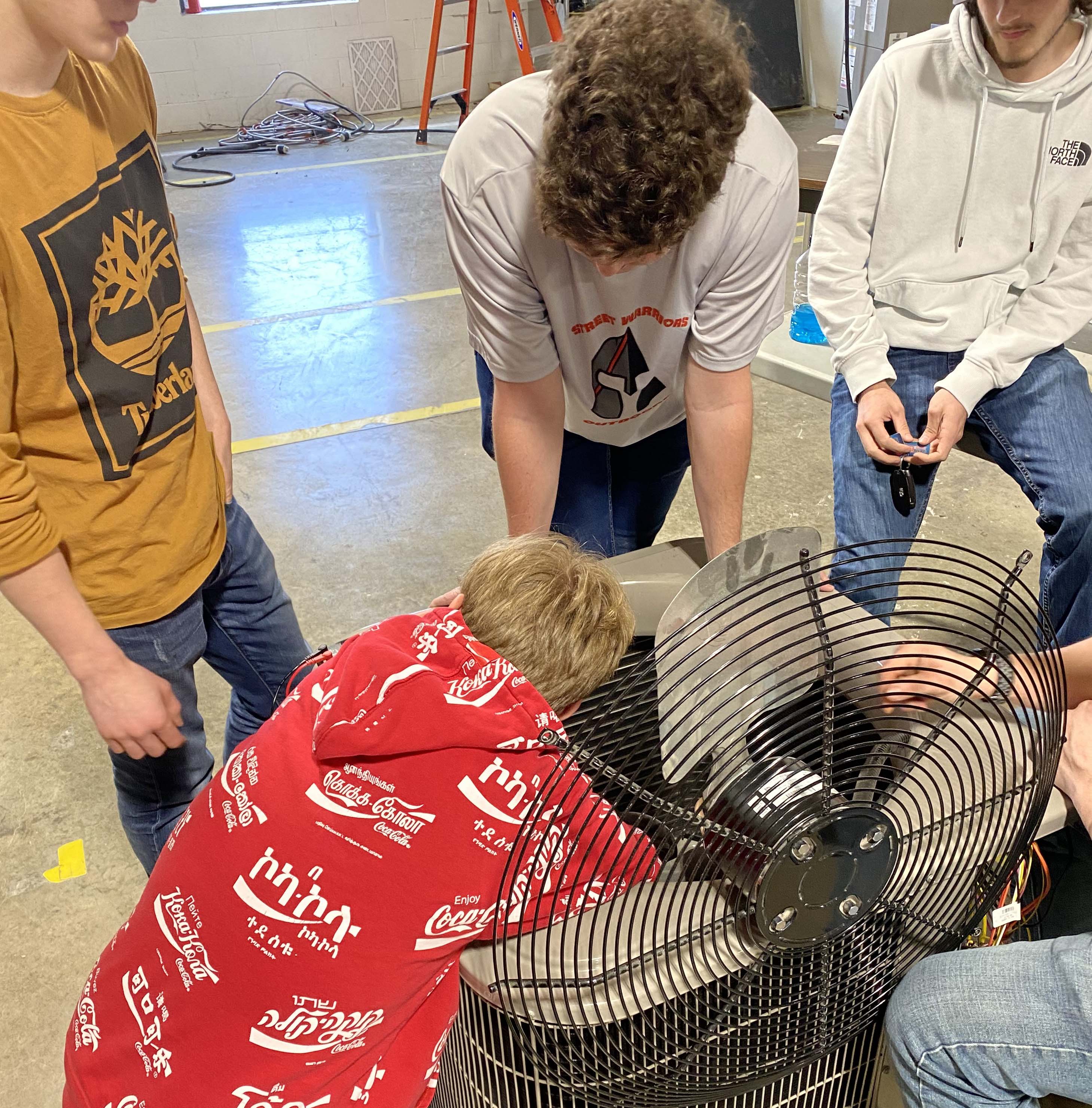 A student working on an HVAC unit in the training lab.