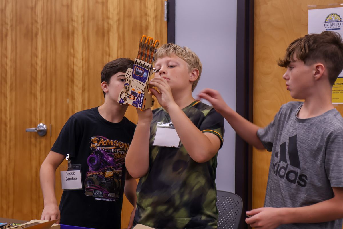 Middle school students building a model hand at a summer career camp.